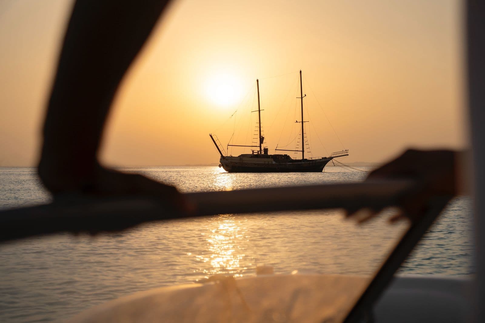 Sailing boat at sunset off Ozirea Island